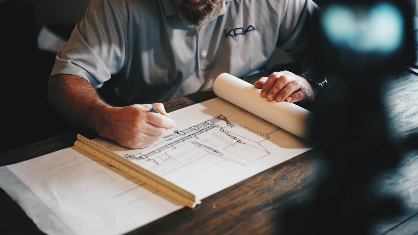 Hands reviewing architectural plans on a desk